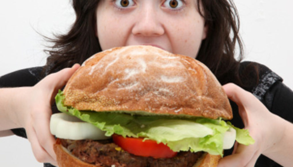 This is not a photo of me, or of a Fat Boy Burger. This is a stock photo of a woman eating a big burger. But it kind of makes the point, doesnt it?